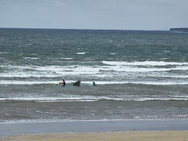 lots of wind swell, a few beginner surfers in the shallows
